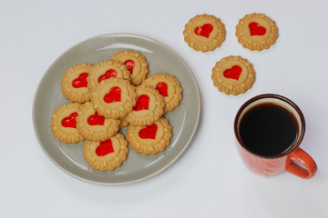 Valentines day heart shaped red jam filled cookies on plate isolated on white .top view.space for text and copy