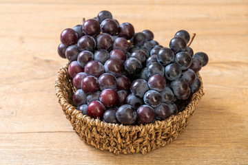 fresh black grapes on white background