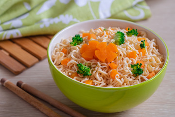 Instant noodle with vegetables in bowl