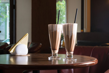 glasses with milk shake, coffee and chocolate cocktail on restaurant table