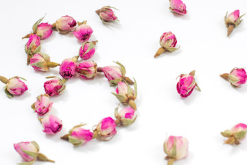 Greeting Card International Women's Day on March 8th. Dry pink roses in the form of number eight.
