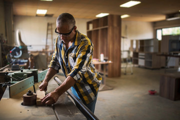 the master uses a woodworking machine