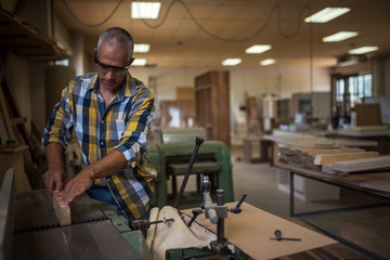 Fototapeta premium the master uses a woodworking machine