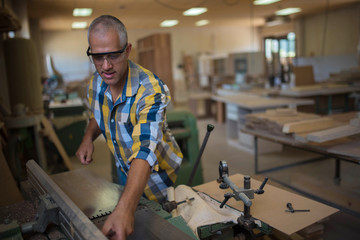 the master uses a woodworking machine