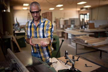 the master uses a woodworking machine