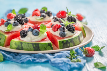 Fresh and sweet watermelon pizza with cream and fresh fruits