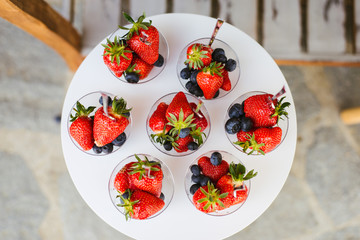 strawberries and blue berries on an elegant setting 