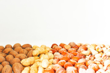 Various nuts selection: hazelnuts, pistachio and pecans in glass,space for copy or text,selective focus