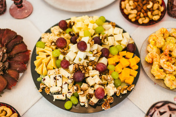 food platter with cheese nuts and grapes 