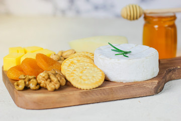 cheese plate,camembert cheese ,rosemary ,crackers,dry apricot and walnuts