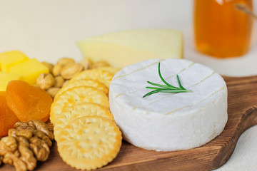 cheese plate,camembert cheese ,rosemary ,crackers,dry apricot and walnuts