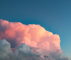 pink clouds at sunset against a blue sky © studybos