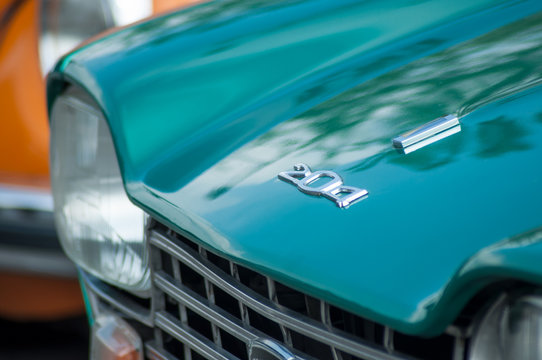 Closeup of green Peugeot 204 parked in vintage exhibition cars