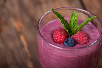 Smoothie with raspberries and blueberries with mint leaves with yogurt