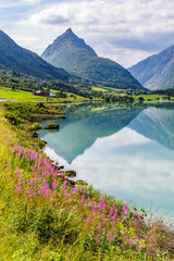 Mountain panorama with mountain Eggenipa reflecting in a lake in Gloppen along highway E39 in Sogn og Fjorden county in Norway