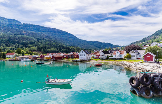 View at Solvorn, a picturesque little village with white wooden houses along Lustrafjorden on a summer day in Sogn og Fjordane county in Norway.