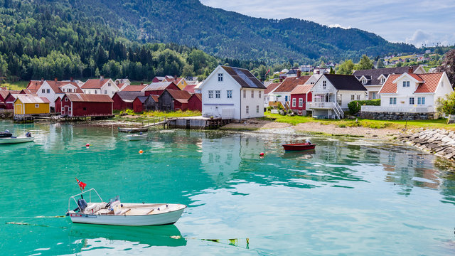 View at Solvorn, a picturesque little village with white wooden houses along Lustrafjorden on a summer day in Sogn og Fjordane county in Norway.