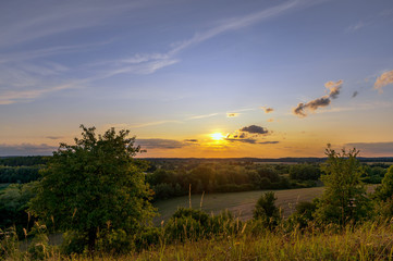 A beautiful sunset with a golden sunshine on a late summer evening. Concept: landscape or travel