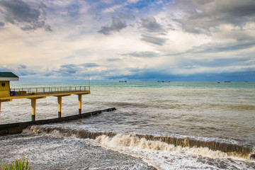 Fototapeta na wymiar Sea, pier, clouds, the weather is changing.