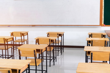 School empty classroom or lecture room interior with desks chair iron wooden whiteboard for studying lessons of secondary education in high school thailand. Learning and Back to school concept