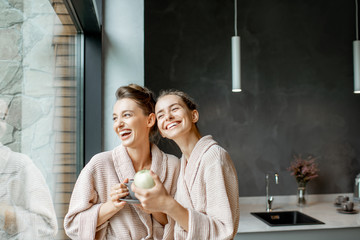 Women in bathrobes indoors