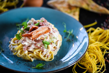 fresh italian spaghetti carbonara with tasty ingredients - cream, egg, bacon