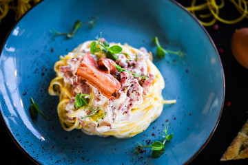 fresh italian spaghetti carbonara with tasty ingredients - cream, egg, bacon