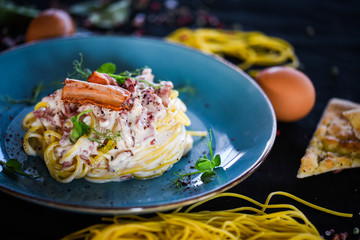 fresh italian spaghetti carbonara with tasty ingredients - cream, egg, bacon