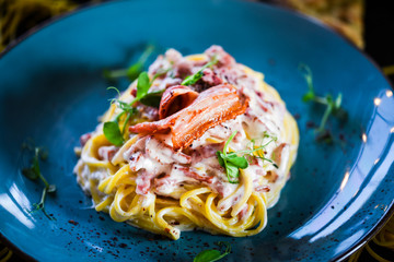 fresh italian spaghetti carbonara with tasty ingredients - cream, egg, bacon