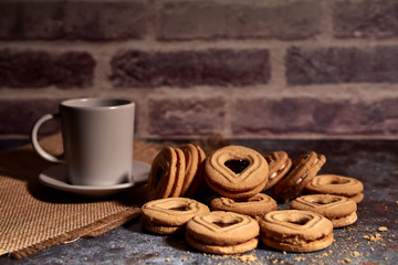 delicious bunch of sweet cookies next to a rich cup of hot milk