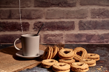 delicious bunch of sweet cookies next to a rich cup of hot milk
