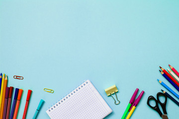 Top view of school and office supplies on Blue blackboard. Back to school concept. Top view.Student creative desk.