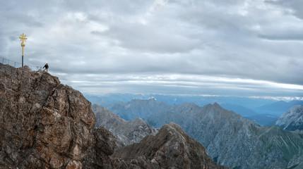 Fototapeta premium Tourist on the peak of Zugspitze mountain. Hiking and active life concept