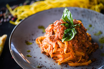 delicious italian spaghetti bolognese with minced beef sauce, tomatoes, carrots & fresh basil 