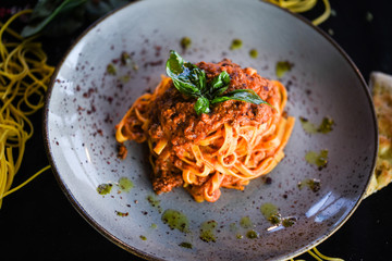 delicious italian spaghetti bolognese with minced beef sauce, tomatoes, carrots & fresh basil 