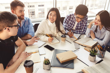 Students in library sharing information and preparing for exam