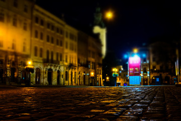 Fototapeta na wymiar Illuminated street of old european town at night. Tilt-shift effect