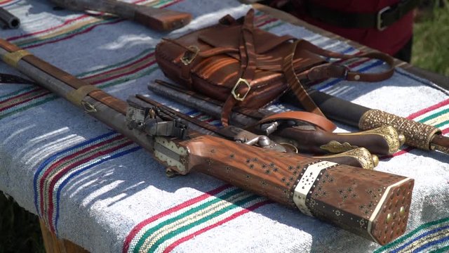 Old guns and rifles on a table