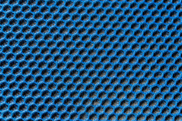 Blaues Gewebe mit elastischer und gleichmäßiger Wabenstruktur und schwarzem Polsteruntergrund als...