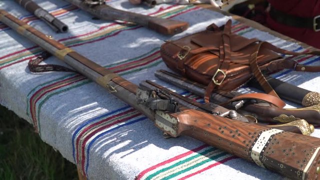 Old guns and rifles on a table