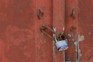 Old painted door with lock with security text