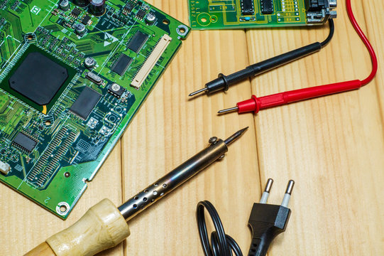 Services for the production of electronics and repair on a wooden background.