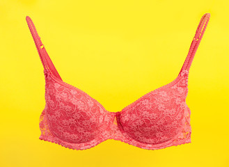 Pink bra on yellow