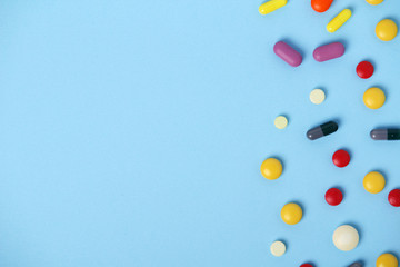 Medical background formed with different bright pills with copy space