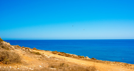  colorful pristine nature of the coast of Cyprus cape cavo greco with clear blue water and yellow rocks