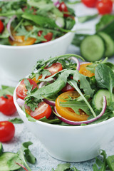Two bowls full of vegetable salad