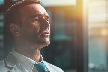 Achieve your goals. Businessman in suit looking away. Copy space on the right side