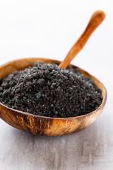 Sea salt in bowl, aroma oil in bottles, Wellness and flowers on grey textured background and flowers on vintage wooden background. Selective focus.