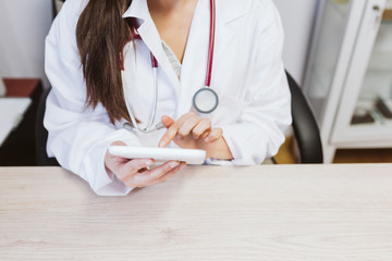 young doctor woman working on tablet at the consult. Modern Medical concept indoors