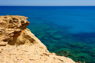  colorful pristine nature of the coast of Cyprus cape cavo greco with clear blue water and yellow rocks